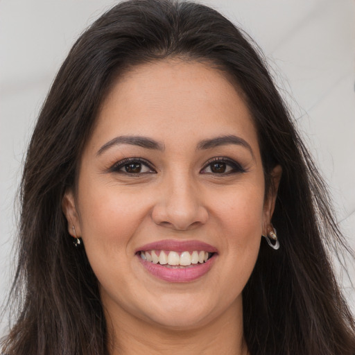 Joyful white young-adult female with long  brown hair and brown eyes