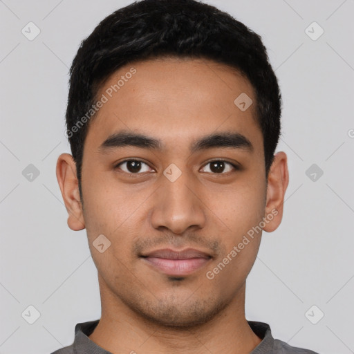 Joyful latino young-adult male with short  black hair and brown eyes