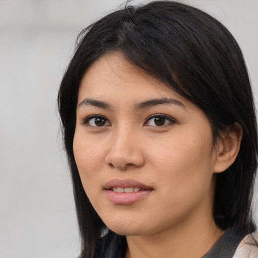 Joyful asian young-adult female with medium  black hair and brown eyes
