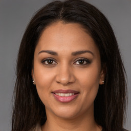 Joyful latino young-adult female with long  brown hair and brown eyes