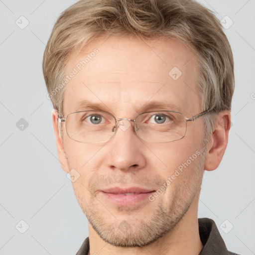 Joyful white adult male with short  brown hair and grey eyes