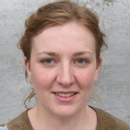 Joyful white young-adult female with medium  brown hair and blue eyes