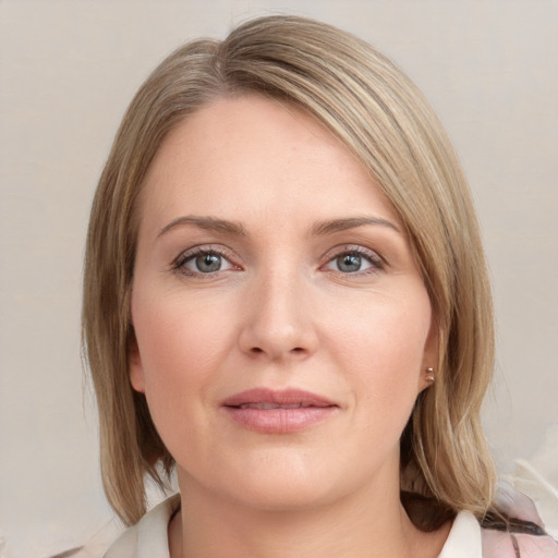 Joyful white young-adult female with medium  brown hair and blue eyes