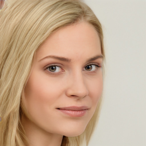 Joyful white young-adult female with long  blond hair and brown eyes