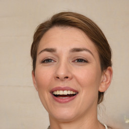 Joyful white adult female with medium  brown hair and brown eyes