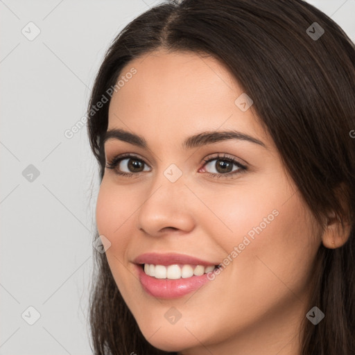 Joyful white young-adult female with long  brown hair and brown eyes