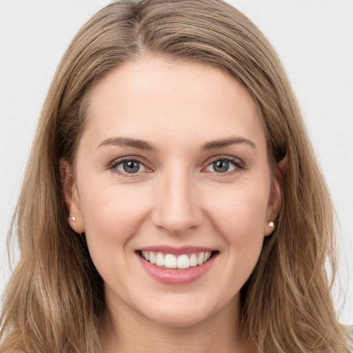 Joyful white young-adult female with long  brown hair and green eyes