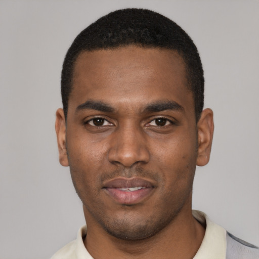 Joyful black young-adult male with short  black hair and brown eyes