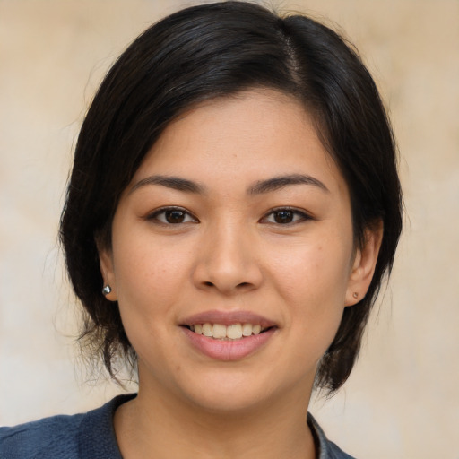Joyful asian young-adult female with medium  brown hair and brown eyes
