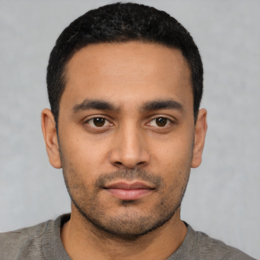Neutral latino young-adult male with short  black hair and brown eyes
