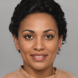 Joyful black adult female with short  brown hair and brown eyes