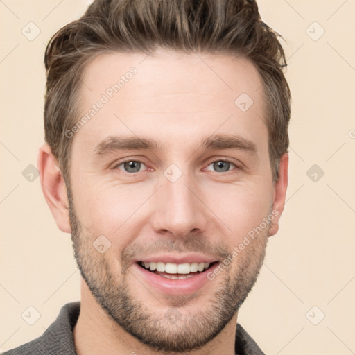 Joyful white young-adult male with short  brown hair and grey eyes