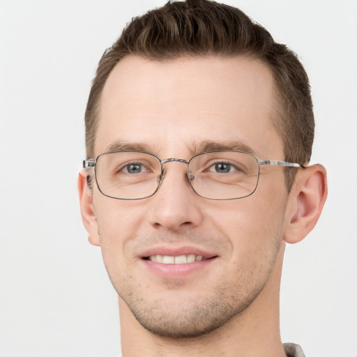 Joyful white young-adult male with short  brown hair and grey eyes