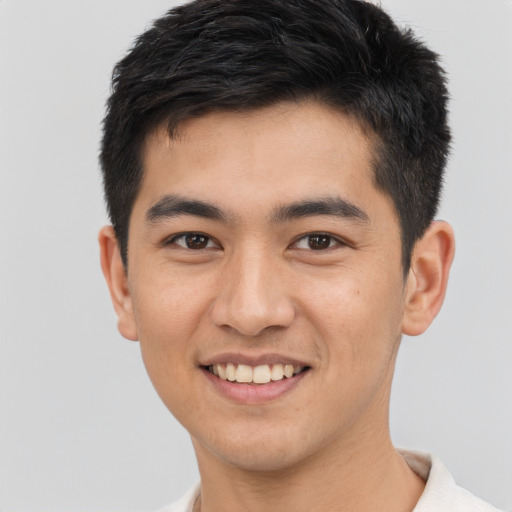Joyful asian young-adult male with short  brown hair and brown eyes