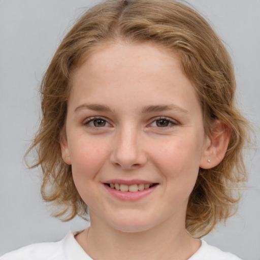 Joyful white child female with medium  brown hair and brown eyes