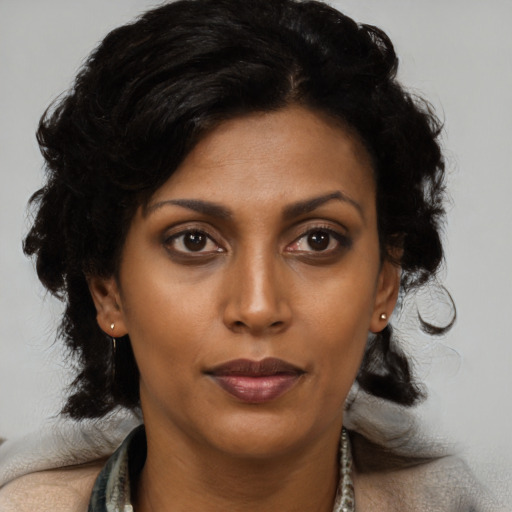Joyful black young-adult female with medium  black hair and brown eyes