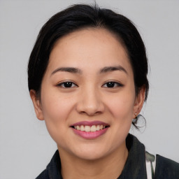 Joyful asian young-adult female with medium  black hair and brown eyes