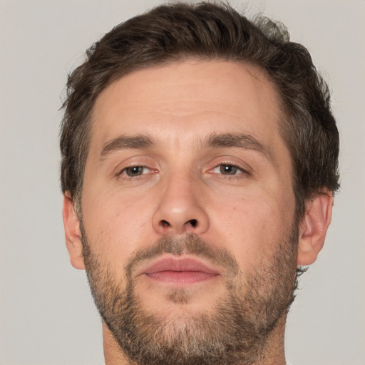 Joyful white adult male with short  brown hair and brown eyes