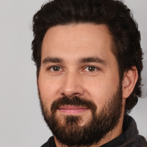 Joyful white adult male with short  brown hair and brown eyes