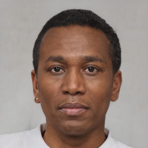 Neutral black adult male with short  black hair and brown eyes