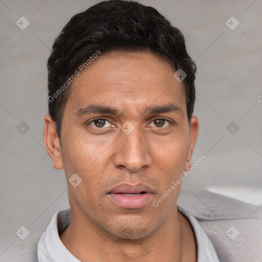 Joyful white adult male with short  black hair and brown eyes