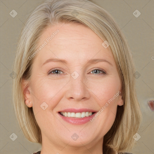 Joyful white adult female with medium  blond hair and grey eyes