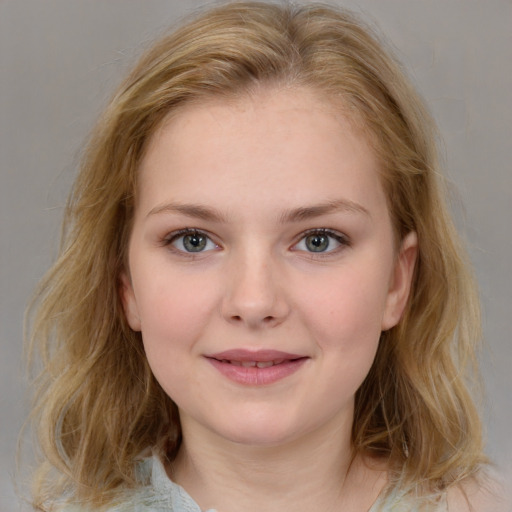 Joyful white young-adult female with medium  brown hair and blue eyes