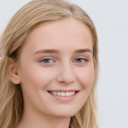 Joyful white young-adult female with long  brown hair and blue eyes