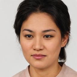 Joyful latino young-adult female with medium  brown hair and brown eyes