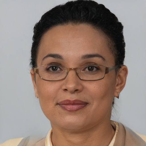 Joyful latino adult female with short  brown hair and brown eyes