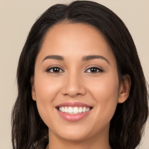 Joyful white young-adult female with long  brown hair and brown eyes