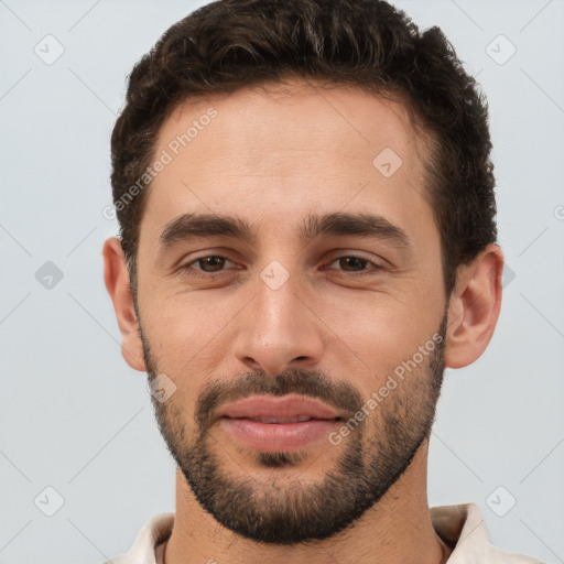 Joyful white young-adult male with short  brown hair and brown eyes