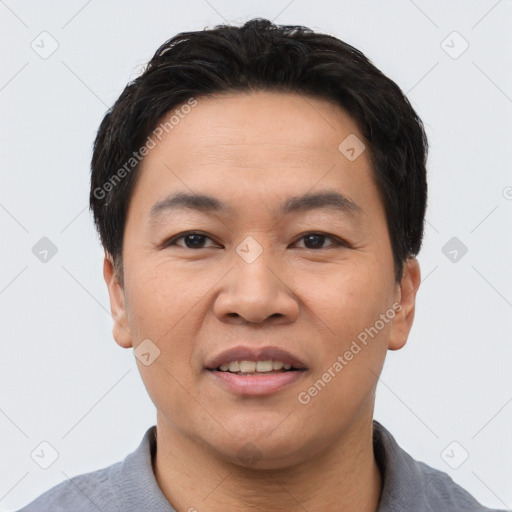 Joyful asian young-adult male with short  black hair and brown eyes