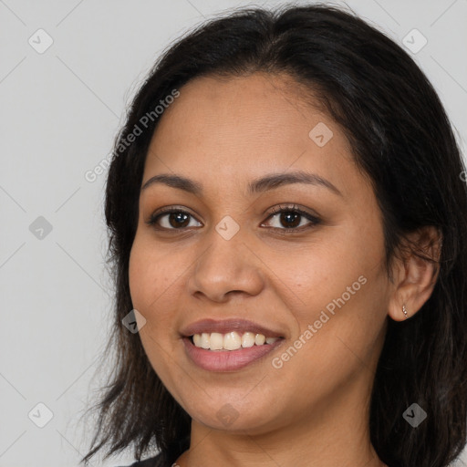 Joyful latino young-adult female with long  brown hair and brown eyes