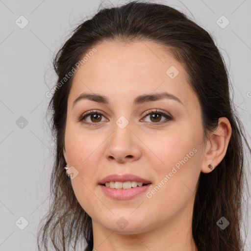 Joyful white young-adult female with long  brown hair and brown eyes