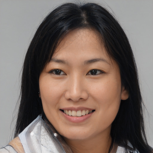 Joyful white young-adult female with medium  black hair and brown eyes