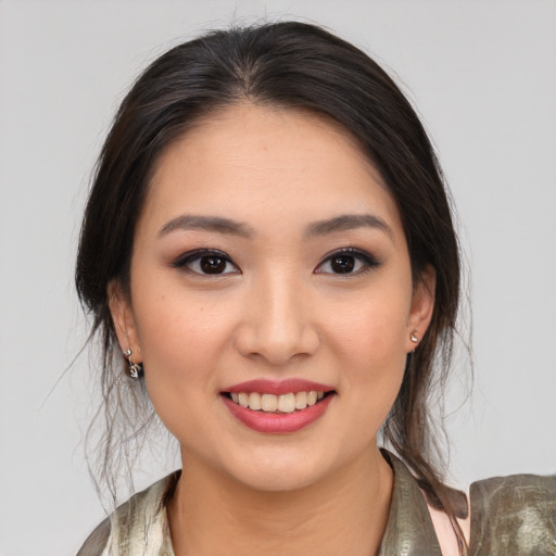 Joyful white young-adult female with medium  brown hair and brown eyes