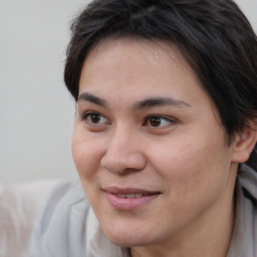 Joyful white young-adult female with medium  brown hair and brown eyes