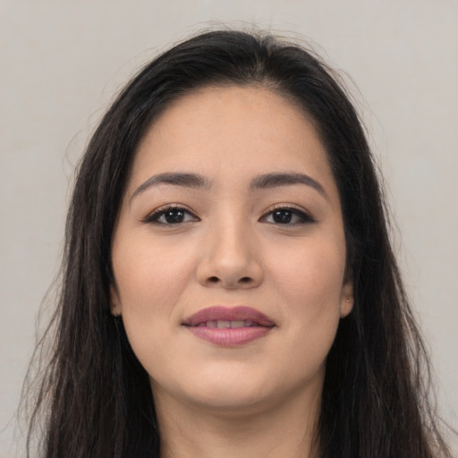 Joyful asian young-adult female with long  brown hair and brown eyes