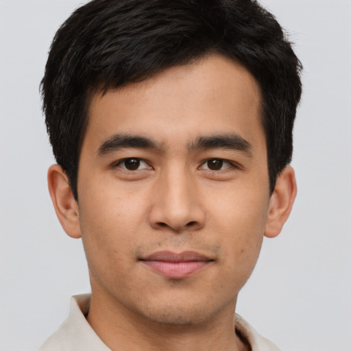Joyful asian young-adult male with short  brown hair and brown eyes