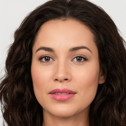 Joyful white young-adult female with long  brown hair and brown eyes