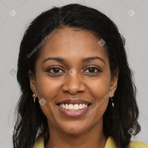 Joyful black young-adult female with long  brown hair and brown eyes