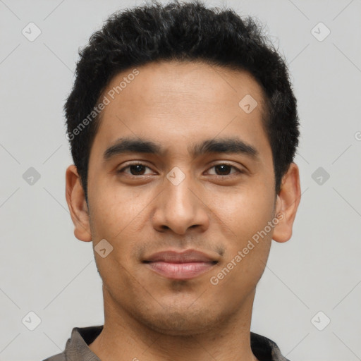 Joyful latino young-adult male with short  black hair and brown eyes