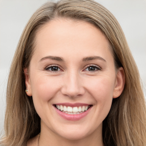 Joyful white young-adult female with long  brown hair and grey eyes