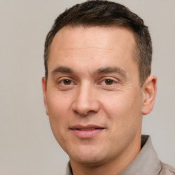 Joyful white adult male with short  brown hair and brown eyes