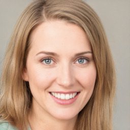 Joyful white young-adult female with long  brown hair and green eyes