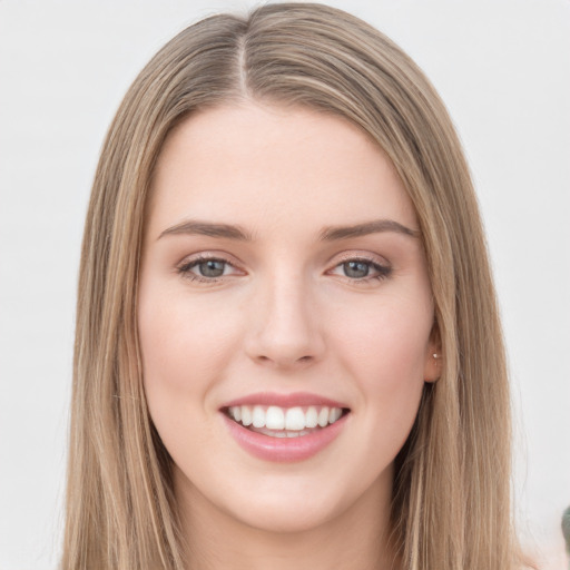 Joyful white young-adult female with long  brown hair and green eyes