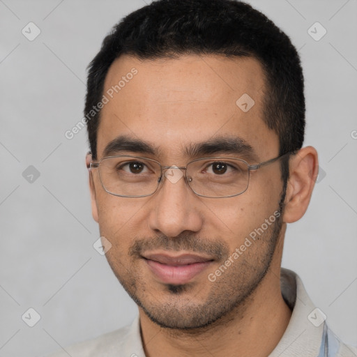 Joyful white young-adult male with short  black hair and brown eyes