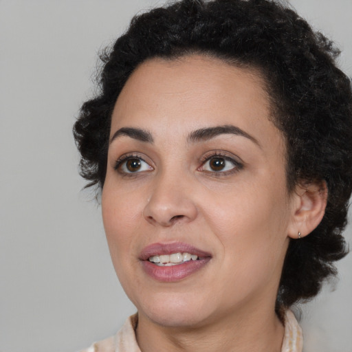 Joyful black young-adult female with medium  brown hair and brown eyes