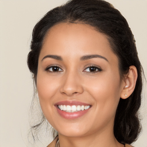 Joyful latino young-adult female with long  brown hair and brown eyes